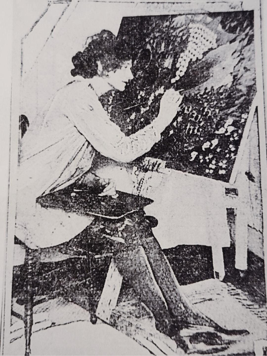 Marian Spore painting fruit and flowers on a large canvas.